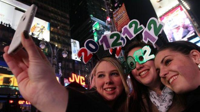 High on hope, world rings in new year, sheds no tears for 2011